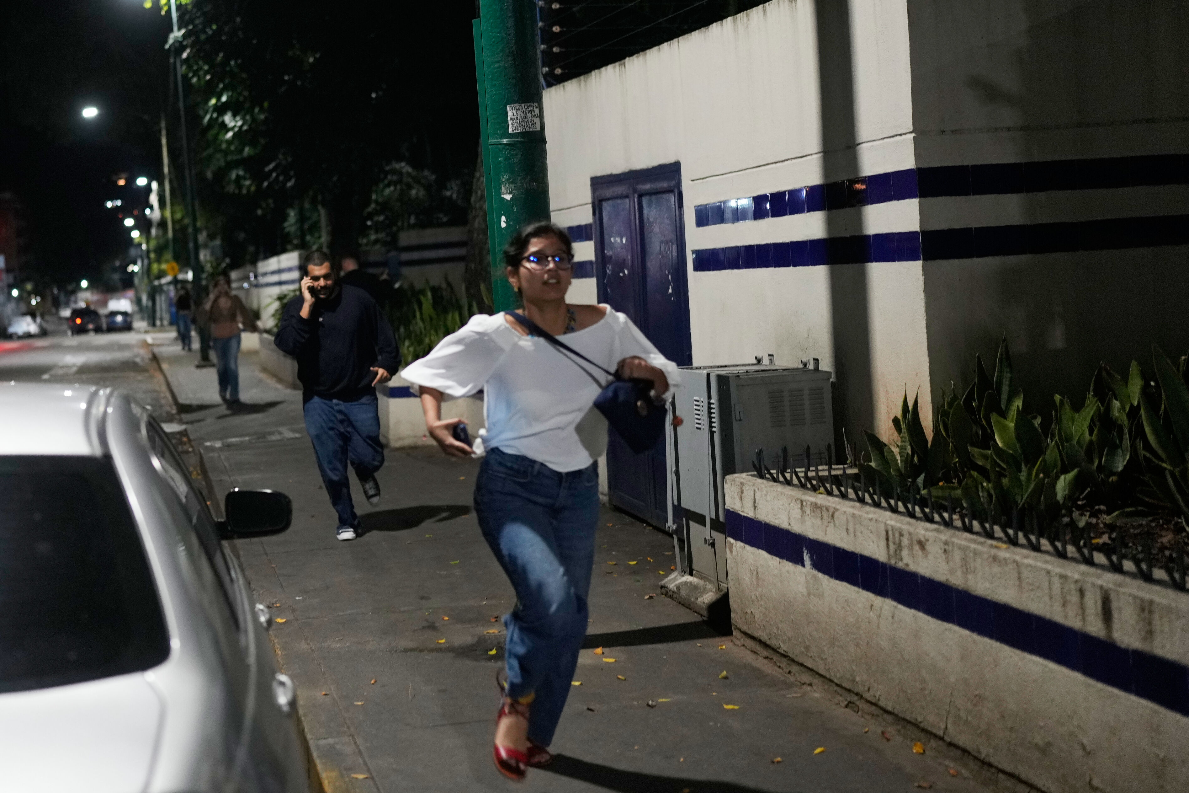 ▲▼委內瑞拉卡拉卡斯（Caracas）傳出爆炸聲並出現低飛飛機，行人在街頭奔跑。（圖／達志影像／美聯社）